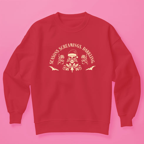 Christmas sweatshirt with "SEASONS SCREAMINGS, DARKLING" text arched over a skull wearing Santa hat. Bats, flowers, and ornate designs surround the skull in vintage-inspired style.